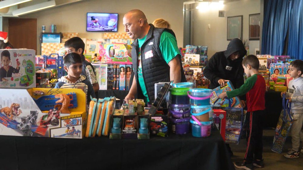 Holiday Toy Drive – Purposeful Giving Alliance Volunteer distributing toys to children at Purposeful Giving Alliance holiday toy drive event in Arizona